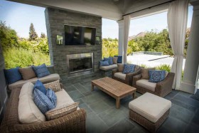 covered-patio-with-fireplace-and-outdoor-tv